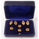 A very high purity gold dress set, comprising a pair of cufflinks set four rubies and four studs,