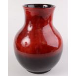 A large Moorcroft purple and red lustre glazed vase, with an ovoid body,