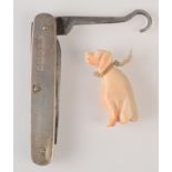 A carved pale pink coral seated hound fob and an Edwardian silver mounted,