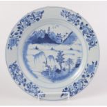 A Chinese blue and white porcelain dish, 18th century, decorated with a river scene,