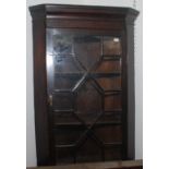 A hanging glazed small corner cupboard.