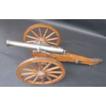 A scale model of a field gun, the steel barrel stamped 'SPAIN' on a wooden carriage,