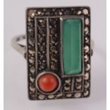 A stylish European Art Deco ring set red coral, marcasite and 'jade'.
