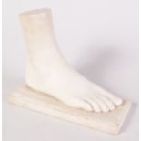 A Grand Tour style carved marble foot on a rectangular plinth, possibly 19th century, height 21cm,