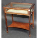 A good late Victorian mahogany display table with blind fret carving to the lid and legs,