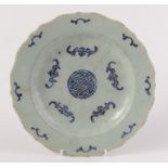 A Chinese porcelain dish decorated with a pale celadon glaze,