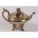 A Victorian pear shaped teapot on four acanthus capped scrolling legs by James Dixon,