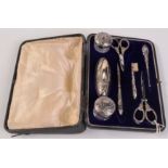 An Edwardian silver mounted eight piece manicure set.