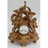 A gilt metal mantel clock, 19th century, with a pair of winged cherubs above a 10cm enamel dial,