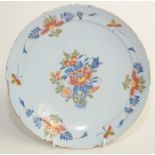 A Delft pottery polychrome plate, 18th century, with a central floral spray within a similar border,