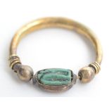 An Egyptian gold ring set a revolving seal.
