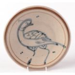 A Studio Pottery plate decorated with a stylised bird, diameter 18.7cm.