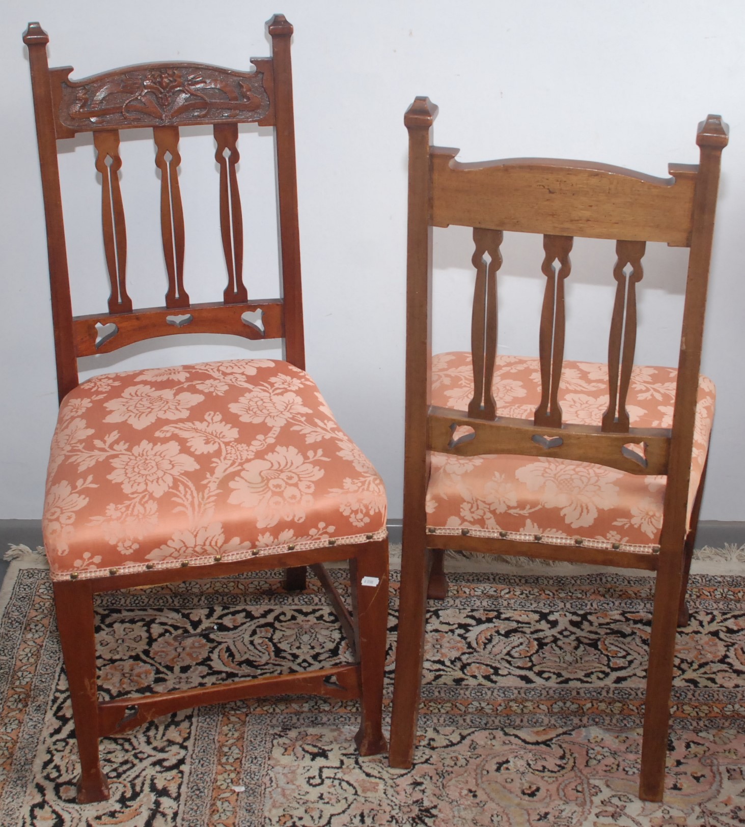 A set of six Art Nouveau carved walnut dining chairs.