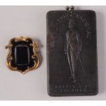A Daffis & Co advertising folding clothes brush, together with a Victorian memoriam brooch.