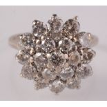 An 18ct white gold diamond peg set cluster ring.