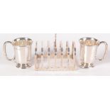 A silver toast rack and a pair of silver christening mugs. 7.5oz.