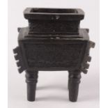 A Chinese bronze rectangular bodied ding with a waisted rectangular neck,