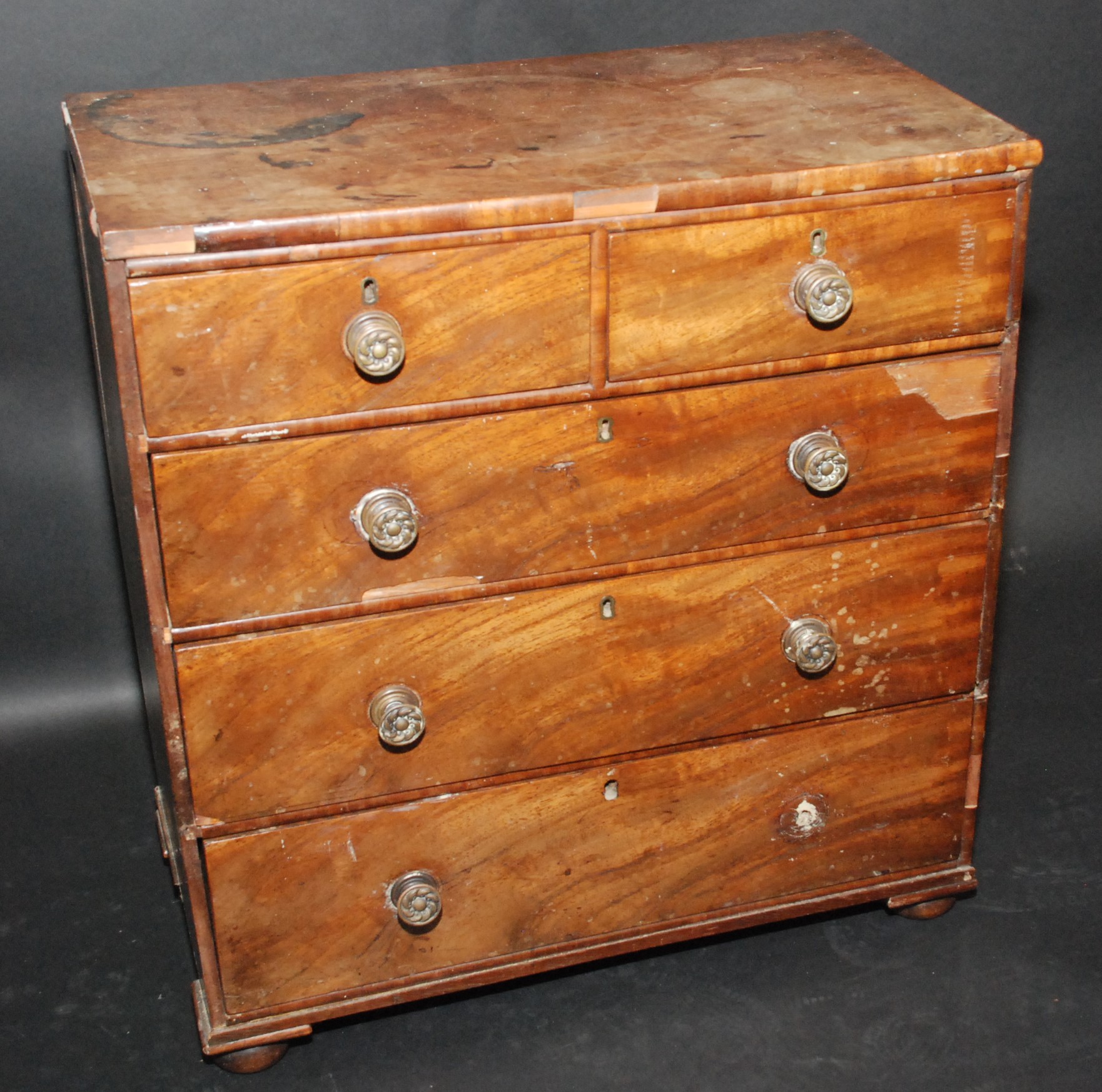 A mahogany miniature chest of drawers, 19th century, with two short and three long drawers,