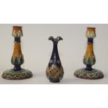 A pair of Doulton Lambeth stoneware candlesticks of baluster form,