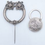 A silver talisman padlock and a silver Celtic Tara brooch.