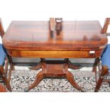 A Regency inlaid, fold top card table on four sabre legs with lions paw feet, width 91.5cm.