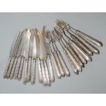 A set of silver handled knives and forks, comprising twelve knives and eleven forks,