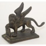 A 19th century Venetian bronze winged lion of St Mark, length 11cm.