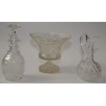 A large cut glass footed bowl, height 23.5cm and a cut glass decanter and ewer.