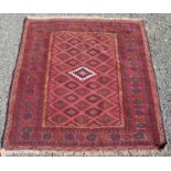 A Persian style wool rug, the serrated diamond motif medallion, within multiple borders,