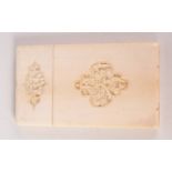 A Chinese ivory card case, 19th century, the cartouches decorated with carved figures on a balcony,