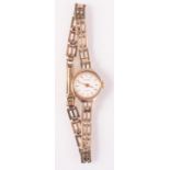 An Accurist ladies quartz 9ct gold cased wristwatch on 9ct gold bracelet.