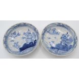 A pair of Chinese export blue and white porcelain dishes, each decorated with river scenes,