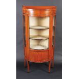 A half round satinwood veneered display cabinet in Sheraton style with inlaid ebony lines,
