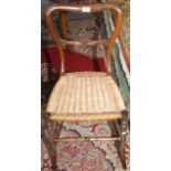 A Victorian rosewood balloon back bedroom chair on turned splayed legs.