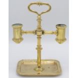 A brass twin candlestick in 18th century style with carrying handle and rectangular tray base.