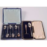 A set of six silver coffee spoons, cased, and a child's silver spoon and pusher, cased.