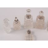 Five silver mounted perfume bottles and one other toilet bottle.