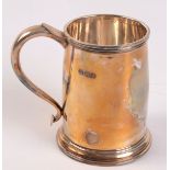 A plain silver pint mug in early George III style, the S handle with heart base, Sheffield 1931.