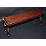 A William IV mahogany window seat, a turned bar at each end on turned tapering legs, width 102cm.