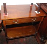 A walnut serving table with single drawer on fluted supports with low shelf, width 86cm.