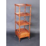 A good Regency mahogany four tier whatnot with a single drawer on short turned legs with brass