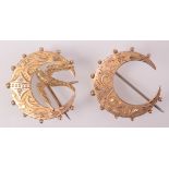 Two Victorian gold crescent brooches.