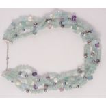 A multi strand aquamarine, amethyst and fresh water pearl necklace.