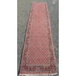 A north west Persian runner, the red field decorated with the all over Herati pattern,