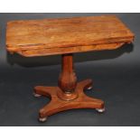 A rosewood veneered Victorian fold top card table with hexagonal section vase pedestal on quadruple