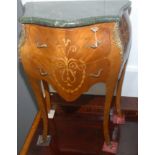 A bombe marquetry marble topped commode in Louis XV style.