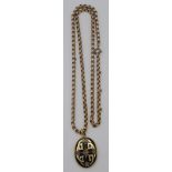 A black enamel and diamond set gold locket on a gilt chain.