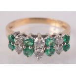 A ring set three pairs of good bright diamonds and four pairs of emeralds.