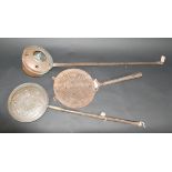 Two copper warming pans and a large metal sieve, length 75cm.