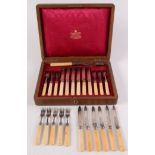 A set of six Mappin & Webb plated engraved fruit knives and forks with ivory handles,